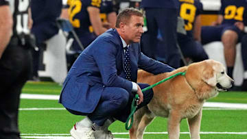 Jan 8, 2024; Houston, TX, USA; ESPN analyst Kirk Herbstreit walks his dog Ben before the 2024 College Football Playoff national championship game between the Michigan Wolverines and the Washington Huskies at NRG Stadium.
