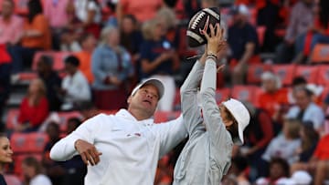 Oct 21, 2023; Auburn, Alabama, USA;  Mississippi Rebels head coach Lane Kiffin and his son Knox battle for the ball before a game against the Auburn Tigers at Jordan-Hare Stadium. Mandatory Credit: John Reed-Imagn Images