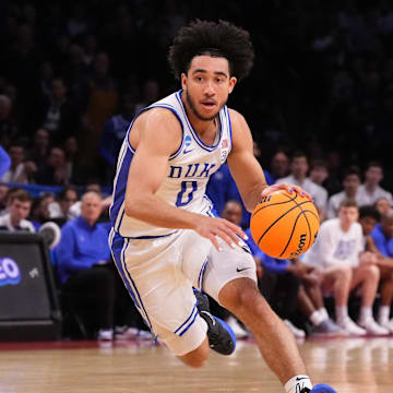 Mar 24, 2024; Brooklyn, NY, USA; Duke Blue Devils guard Jared McCain (0) dribbles the ball past James Madison Dukes guard Xavier Brown (0) in the second round of the 2024 NCAA Tournament  at Barclays Center. Mandatory Credit: Robert Deutsch-USA TODAY Sports