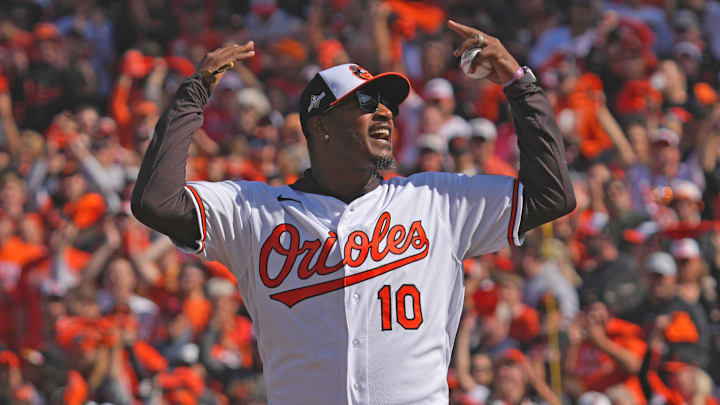 Oct 7, 2023; Baltimore, Maryland, USA; Former Baltimore Orioles outfielder Adam Jones reacts after throwing out the ceremonial first pitch prior to the game against the Texas Rangers during game one of the ALDS for the 2023 MLB playoffs at Oriole Park at Camden Yards. Mandatory Credit: Mitch Stringer-Imagn Images