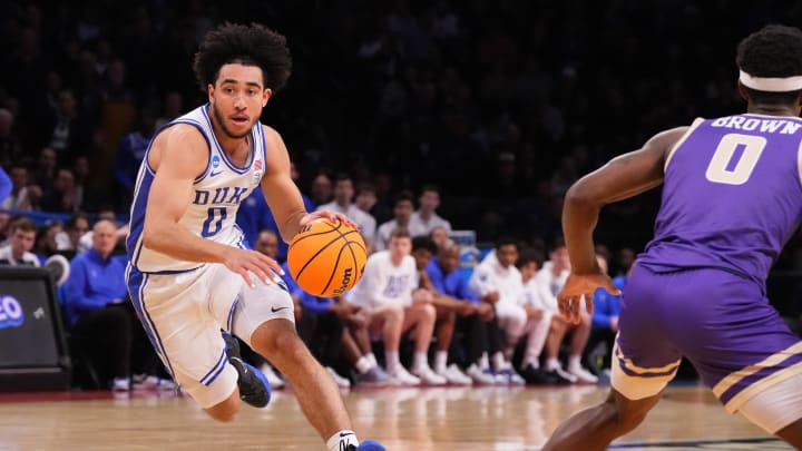 Mar 24, 2024; Brooklyn, NY, USA; Duke Blue Devils guard Jared McCain (0) dribbles the ball past James Madison Dukes guard Xavier Brown (0) in the second round of the 2024 NCAA Tournament  at Barclays Center. Mandatory Credit: Robert Deutsch-USA TODAY Sports