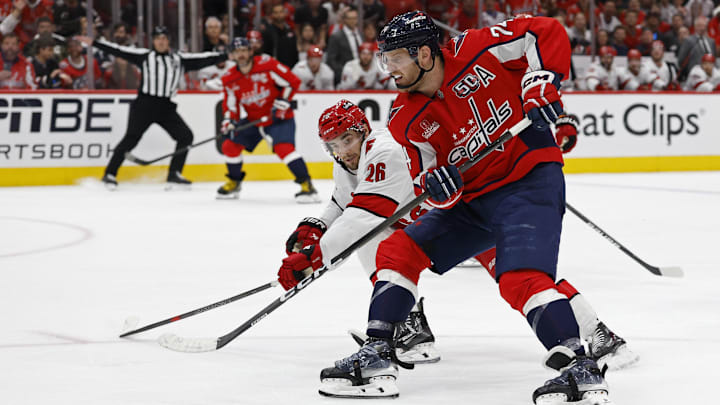 May 15, 2025; Washington, District of Columbia, USA; Washington Capitals defenseman John Carlson (74) skates with the puck on goal as Carolina Hurricanes defenseman Sean Walker (26) defends in the third period in game five of the second round of the 2025 Stanley Cup Playoffs at Capital One Arena. Mandatory Credit: Geoff Burke-Imagn Images May 15, 2025; Washington, District of Columbia, USA; Washington Capitals defenseman John Carlson (74) skates with the puck on goal as Carolina Hurricanes defenseman Sean Walker (26) defends in the third period in game five of the second round of the 2025 Stanley Cup Playoffs at Capital One Arena. Mandatory Credit: Geoff Burke-Imagn Images