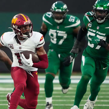 Dec 24, 2023; East Rutherford, New Jersey, USA;  Washington Commanders wide receiver Terry McLaurin (17) runs for a second half first down against the New York Jet at MetLife Stadium. Mandatory Credit: Robert Deutsch-Imagn Images