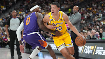 Oct 5, 2022; Las Vegas, Nevada, USA; Los Angeles Lakers forward Cole Swider (20) dribbles around Phoenix Suns forward Torrey Craig (0) during a preseason game at T-Mobile Arena. Mandatory Credit: Stephen R. Sylvanie-Imagn Images