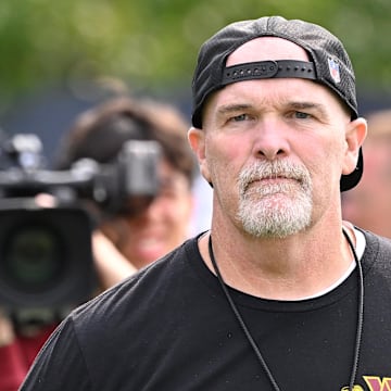 Aug 6, 2025; Foxborough, MA, USA; Washington Commanders head coach Dan Quinn walks to the podium for a press conference before training camp at Gillette Stadium. Mandatory Credit: Eric Canha-Imagn Images