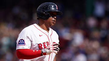 May 8, 2025; Boston, Massachusetts, USA; Boston Red Sox designated hitter Rafael Devers (11) hits a home run against the Texas Rangers in the seventh inning at Fenway Park. Mandatory Credit: David Butler II-Imagn Images
