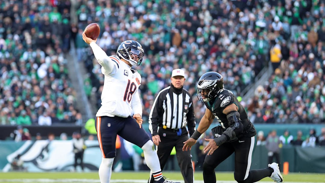 Nov 28, 2025; Philadelphia, Pennsylvania, USA; Chicago Bears quarterback Caleb Williams (18) passes the ball under pressure from Philadelphia Eagles linebacker Nolan Smith Jr. (3) during the first quarter of the game at Lincoln Financial Field. Mandatory Credit: Bill Streicher-Imagn Images