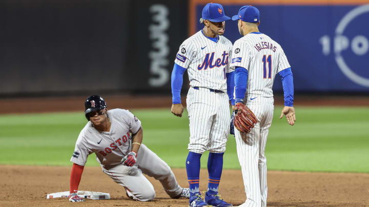 Sep 3, 2024; New York City, New York, USA;  New York Mets shortstop Francisco Lindor (12) and second baseman Jose Iglesias (11) after completing an inning ending double play in the eighth inning against the Boston Red Sox at Citi Field. Mandatory Credit: Wendell Cruz-Imagn Images