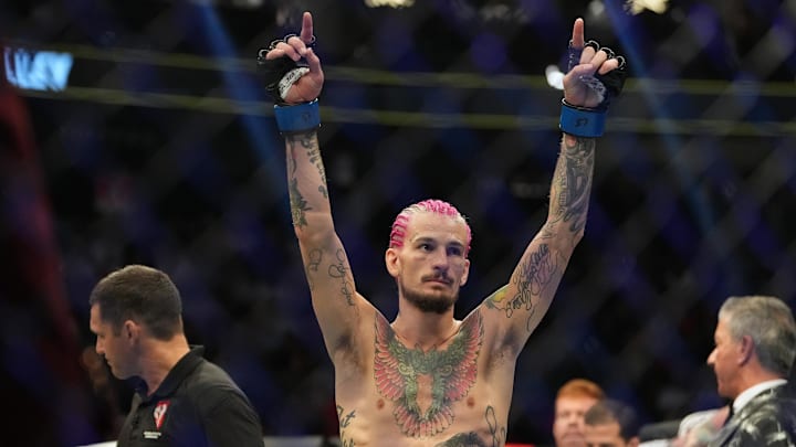 Jul 2, 2022; Las Vegas, Nevada, USA; Pedro Munhoz (red gloves) reacts after his bout against  Sean O'Malley (blue gloves) resulted in a no decision due to an accidental foul during UFC 276 at T-Mobile Arena. Mandatory Credit: Stephen R. Sylvanie-Imagn Images