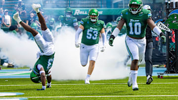 Aug 30, 2025; New Orleans, Louisiana, USA; Tulane Green Wave head coach Jon Sumrall runs out the tunnel with defensive end Gerrod Henderson (10) and safety Tavare Smith (13) against Northwestern Wildcats during the first half at Yulman Stadium. Mandatory Credit: Stephen Lew-Imagn Images