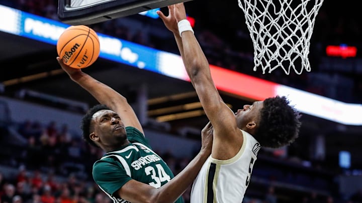 Michigan State forward Xavier Booker (34) dunks against Purdue guard Myles Colvin (5) during the first half of quarterfinal of Big Ten tournament at Target Center in Minneapolis, Minn. on Friday, March 15, 2024.