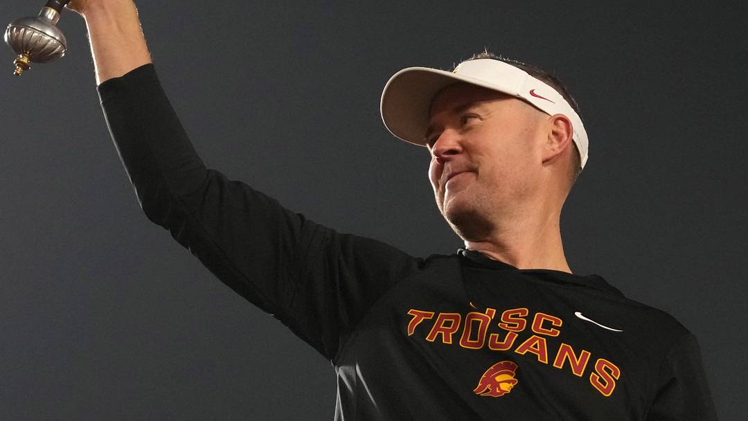 Nov 29, 2025; Los Angeles, California, USA; Southern California Trojans head coach Lincoln Riley leads the Spirit of Troy marching band in a rendition of Tribute to Troy after teh game against the UCLA Bruins at United Airlines Field at Los Angeles Memorial Coliseum. Mandatory Credit: Kirby Lee-Imagn Images