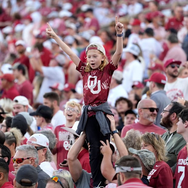 Oklahoma fans watch during a college football game between the University of Oklahoma Sooners (OU) and the Houston Cougars.