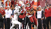 Oct 18, 2025; Fayetteville, Arkansas, USA; Arkansas Razorbacks quarterback Taylen Green (10) rushes during the fourth quarter as Texas A&M Aggies cornerback Jordan Shaw (8) defends at Donald W. Reynolds Razorback Stadium. Mandatory Credit: Nelson Chenault-Imagn Images