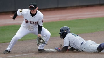 Cedar Rapids Kernels' Gabriel Gonzalez (16) is safe at third base against Wisconsin Timber Rattlers' Mike Boeve (19) during their baseball game Wednesday, April 17, 2024, at Neuroscience Group Field at Fox Cities Stadium in Grand Chute, Wisconsin.