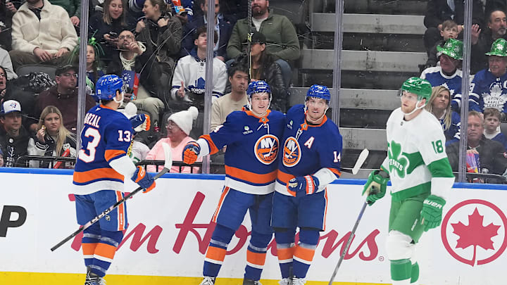Mar 17, 2026; Toronto, Ontario, CAN; New York Islanders center Calum Ritchie (64) scores a goal and celebrates with center Bo Horvat (14) against the Toronto Maple Leafs during the first period at Scotiabank Arena. Mandatory Credit: Nick Turchiaro-Imagn Images