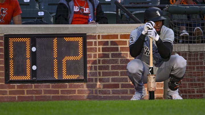 Chicago White Sox outfielder Luis Robert Jr. (88) squats by the on-deck circle before a first inning at-bat against the Balti