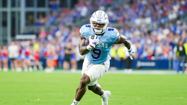 Aug 29, 2024; Kansas City, Kansas, USA; Kansas Jayhawks running back Daniel Hishaw Jr. (9) runs the ball during the first half against the Lindenwood Lions at Children's Mercy Park. 