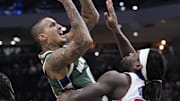 Dec 3, 2025; Milwaukee, Wisconsin, USA; Milwaukee Bucks forward Kyle Kuzma (18) drives to the basket against Detroit Pistons forward Isaiah Stewart (28) in the first half at Fiserv Forum. Mandatory Credit: Michael McLoone-Imagn Images