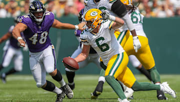 Green Bay Packers quarterback Sean Clifford (6) scrambles away from Baltimore Ravens defensive end Joe Evans (48) during an NFL preseason game on Saturday, August 24, 2024, at Lambeau Field in Green Bay, Wis. 
Tork Mason/USA TODAY NETWORK-Wisconsin