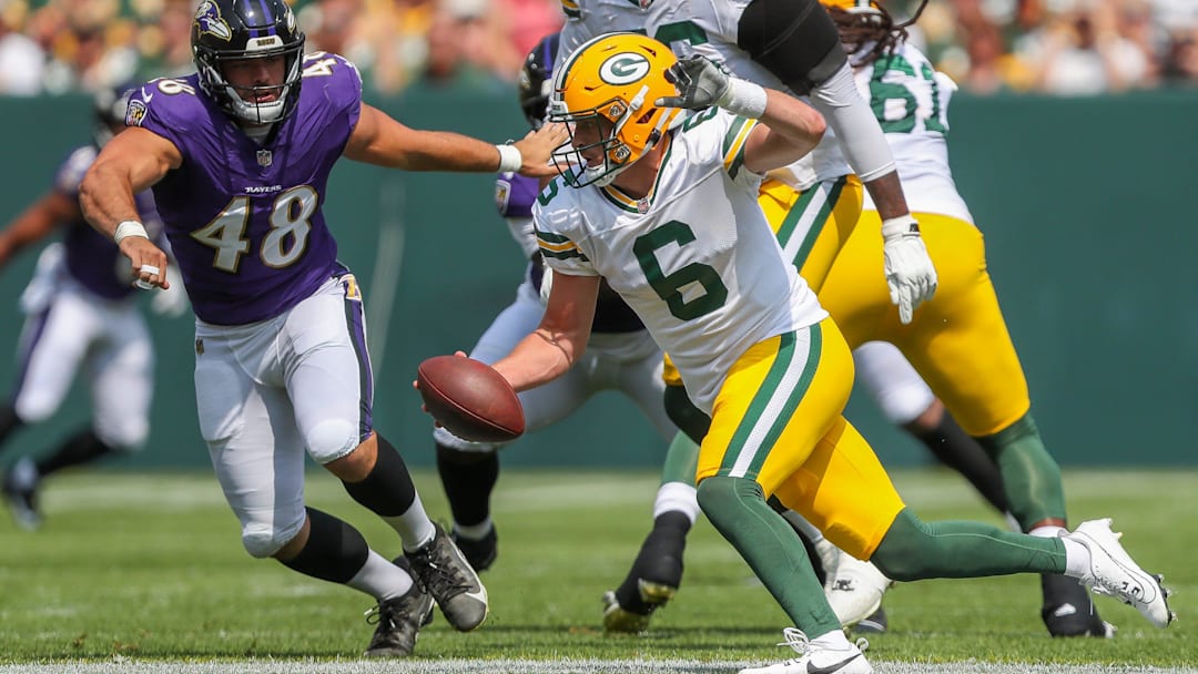 Green Bay Packers quarterback Sean Clifford (6) scrambles away from Baltimore Ravens defensive end Joe Evans (48) during an NFL preseason game on Saturday, August 24, 2024, at Lambeau Field in Green Bay, Wis. 
Tork Mason/USA TODAY NETWORK-Wisconsin