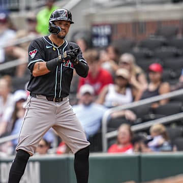 Jun 5, 2025; Cumberland, Georgia, USA; Arizona Diamondbacks Ildemaro Vargas (6) gets a base hit to drive in a run against the Atlanta Braves during the ninth inning at Truist Park. Mandatory Credit: Dale Zanine-Imagn Images