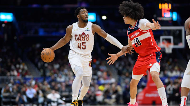 Feb 7, 2025; Washington, District of Columbia, USA; Cleveland Cavaliers guard Donovan Mitchell (45) handles the ball against Washington Wizards forward Kyshawn George (18) during the fourth quarter at Capital One Arena. Mandatory Credit: Reggie Hildred-Imagn Images