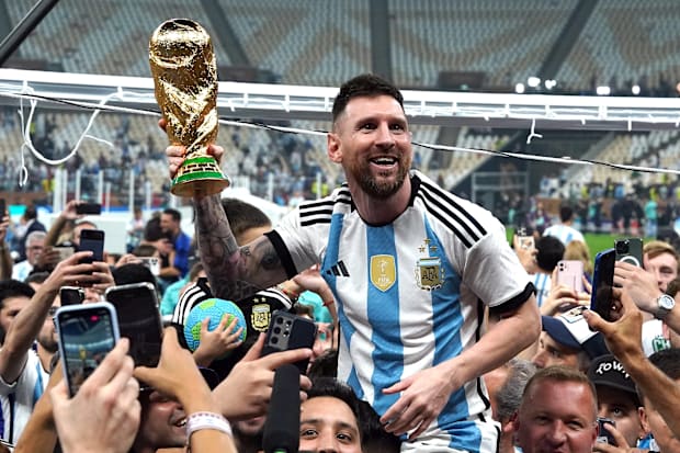 Lionel Messi lifts the World Cup.