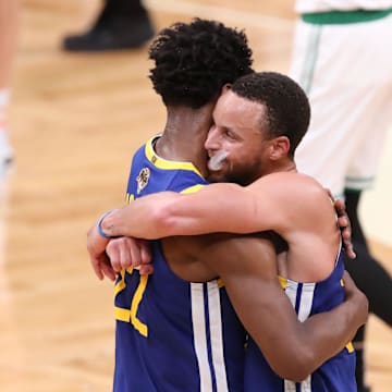 Jun 16, 2022; Boston, Massachusetts, USA; Golden State Warriors guard Stephen Curry (30) hugs Golden State Warriors forward Andrew Wiggins (22) after defeating the Boston Celtics in game six in the 2022 NBA Finals at the TD Garden. Mandatory Credit: Paul Rutherford-Imagn Images