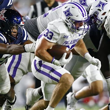 Aug 31, 2024; Oxford, Mississippi, USA; Furman Paladins running back Gavin Hall (33) runs the ball as Mississippi Rebels defensive linemen Chris Hardie (91) attempts to make the tackle during the second half  at Vaught-Hemingway Stadium. Mandatory Credit: Petre Thomas-Imagn Images