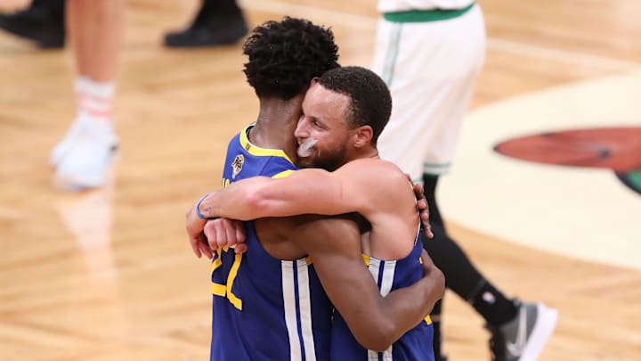 Jun 16, 2022; Boston, Massachusetts, USA; Golden State Warriors guard Stephen Curry (30) hugs Golden State Warriors forward Andrew Wiggins (22) after defeating the Boston Celtics in game six in the 2022 NBA Finals at the TD Garden. Mandatory Credit: Paul Rutherford-Imagn Images