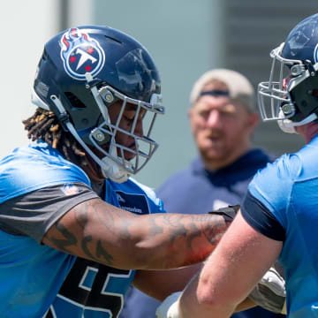 Offensivle lineman JC Latham (55) and Cole Spencer (70) run drills during Tennessee Titans practice at Ascension Saint Thomas Sports Park in Nashville, Tenn., Tuesday, May 21, 2024.
