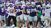Kansas State defensive tackle Damian Ilalio (56), defensive end Travis Bates (39) and defensive tackle Uso Seumalo (99) celebrate fumble recovery vs. Texas Tech.