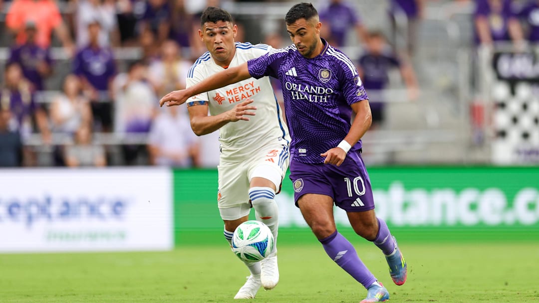 Jun 28, 2025; Orlando, Florida, USA; Orlando City midfielder Martin Ojeda (10) controls the ball from FC Cincinnati defender Gilberto Flores (3) in the first half at Inter&Co Stadium. Mandatory Credit: Nathan Ray Seebeck-Imagn Images