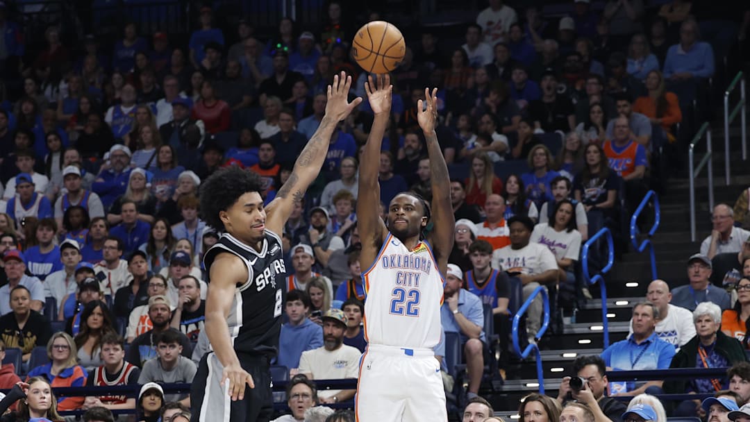 Dec 25, 2025; Oklahoma City, Oklahoma, USA; Oklahoma City Thunder guard Cason Wallace (22) shoots as San Antonio Spurs guard Dylan Harper (2) defends during the second half at Paycom Center. Mandatory Credit: Alonzo Adams-Imagn Images