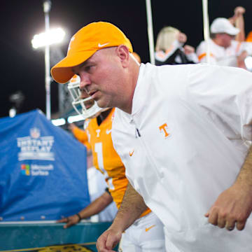 Tennessee football coach Jeremy Pruitt runs onto the field during the Gator Bowl game between Tennessee and Indiana at the TIAA Bank Field in Jacksonville, Fla., Jan. 2, 2020.