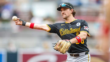 Jun 1, 2025; San Diego, California, USA; Pittsburgh Pirates second baseman Adam Frazier (26) makes the throw to first for an out during the fifth inning against the San Diego Padres at Petco Park. Mandatory Credit: David Frerker-Imagn Images