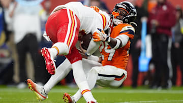 Nov 16, 2025; Denver, Colorado, USA; Denver Broncos cornerback Ja'Quan McMillian (29) sacks Kansas City Chiefs quarterback Patrick Mahomes (15) in the fourth quarter at Empower Field at Mile High. 