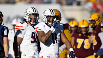 Nov 25, 2023; Tempe, Arizona, USA; Arizona Wildcats edge Taylor Upshaw (11) and defensive lineman Tiaoalii Savea (98) against the Arizona State Sun Devils during the Territorial Cup at Mountain America Stadium. Mandatory Credit: Mark J. Rebilas-USA TODAY Sports