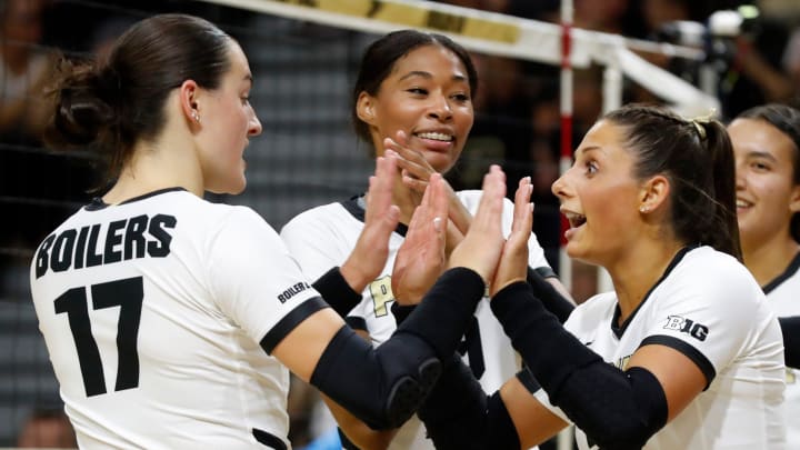 Purdue Boilermakers Evan Hudson (17) and Purdue Boilermakers Chloe Chicoine (2) high-five 