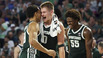 Nov 25, 2025; Fort Myers, Florida, USA; Michigan State Spartans forward Jaxon Kohler (0) reacts to guard Divine Ugochukwu (99) after a basket against the East Carolina Pirates in the first half  at Suncoast Credit Union Arena. Mandatory Credit: Nathan Ray Seebeck-Imagn Images
