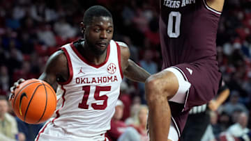Oklahoma Sooners guard Duke Miles (15) moves past Texas A&M Aggies guard Jace Carter (0) during an SEC men's college basketball game between the University of Oklahoma Sooners (OU) and the Texas A&M Aggies at Lloyd Noble Center in Norman, Okla., Wednesday, Jan. 8, 2025. Texas A&M won 80-78.