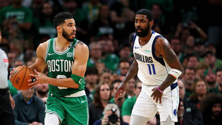 Jun 17, 2024; Boston, Massachusetts, USA; Boston Celtics forward Jayson Tatum (0) handles the ball against Dallas Mavericks guard Kyrie Irving (11) in game five of the 2024 NBA Finals at TD Garden. Mandatory Credit: Peter Casey-USA TODAY Sports