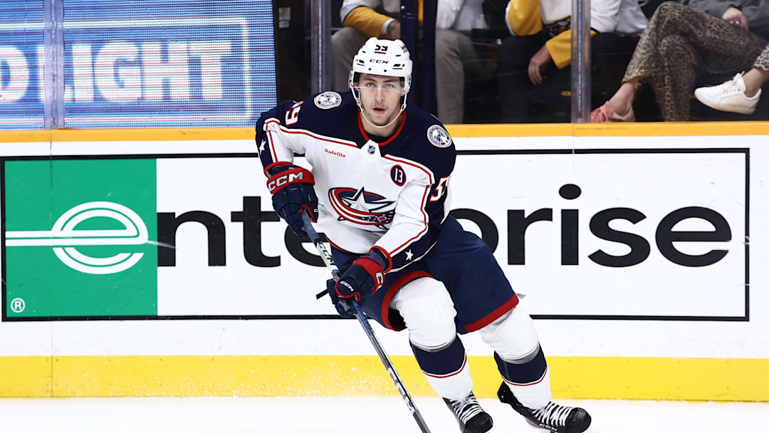 Oct 26, 2024; Nashville, Tennessee, USA; Columbus Blue Jackets right wing Yegor Chinakhov (59) brings the puck around the board in the second period against the Nashville Predators at Bridgestone Arena. Mandatory Credit: Casey Gower-Imagn Images