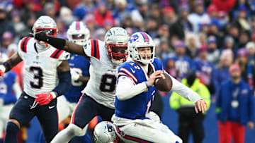 Dec 31, 2023; Orchard Park, New York, USA; Buffalo Bills quarterback Josh Allen (17) is tackled by New England Patriots linebacker Josh Uche (55) and linebacker Ja'Whaun Bentley (8) in the fourth quarter at Highmark Stadium. Mandatory Credit: Mark Konezny-USA TODAY Sports