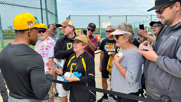 Infielder Termarr Johnson signs autographs and talks to fans gathered to watch the Pittsburgh Pirates practice in February.