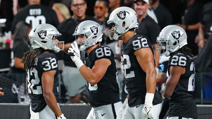 Aug 23, 2024; Paradise, Nevada, USA; Las Vegas Raiders wide receiver Tyreik McAllister (32) celebrates with Las Vegas Raiders tight end John Samuel Shenker (86), Las Vegas Raiders defensive end Elerson Smith (92), and Las Vegas Raiders cornerback M.J. Devonshire (26) after returning a San Francisco 49ers punt for a touchdown during the second quarter at Allegiant Stadium. Mandatory Credit: Stephen R. Sylvanie-USA TODAY Sports