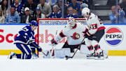 Apr 29, 2025; Toronto, Ontario, CAN; Toronto Maple Leafs center Bobby McMann (74) battles for the puck with Ottawa Senators defenseman Jake Sanderson (85) in the second period during game five of the first round of the 2025 Stanley Cup Playoffs at Scotiabank Arena. Mandatory Credit: Nick Turchiaro-Imagn Images