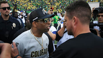 Colorado coach Deion Sanders, left, and Oregon's Dan Lanning meet at midfield after the game in Eugene Saturday, Sept. 23, 2023.