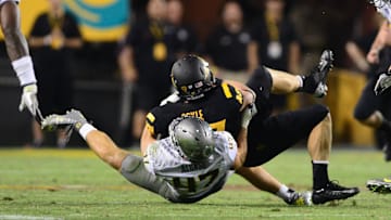 Oct. 18, 2012; Tempe, AZ, USA; Arizona State Sun Devils quarterback Taylor Kelly (10) is tackled by Oregon Ducks linebacker Kiko Alonso (47) at Sun Devil Stadium. Oregon defeated Arizona State 43-21. Mandatory Credit: Mark J. Rebilas-Imagn Images
